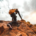 Success woman hiker hiking on sunrise mountain peak - Young woma